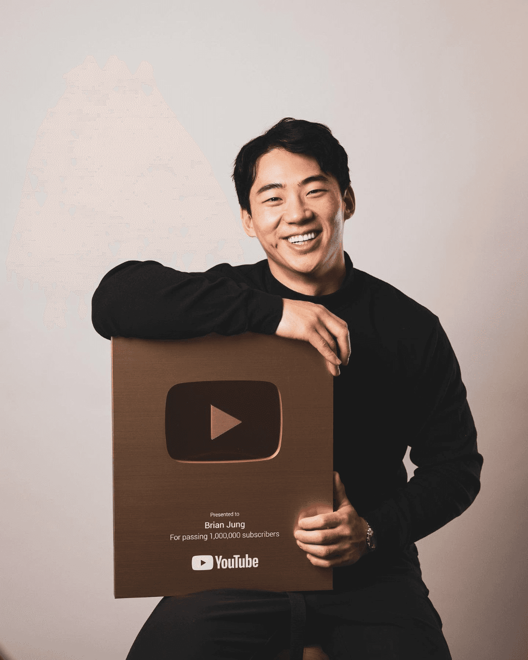 Brian Jung holding his YouTube 1M subscriber play button